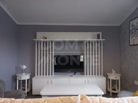 Living room with a white TV unit and a coffee table. - image 12