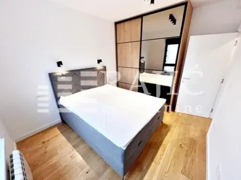 Modern bedroom with a double bed and a built-in mirrored wardrobe. - image 8
