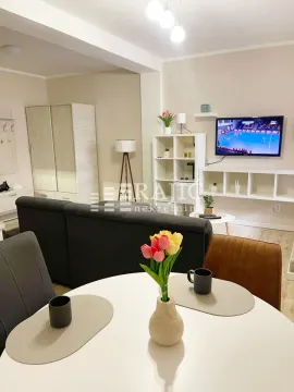 Living room with a dining area in the apartment. - image 2