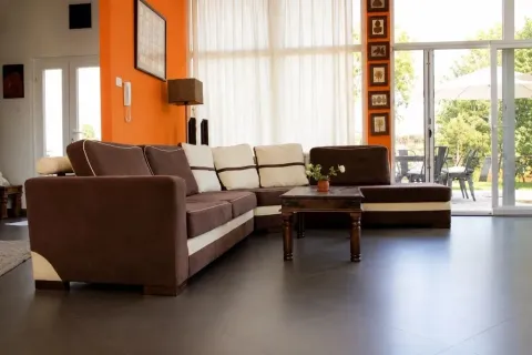 Spacious living room with a sectional sofa and access to the terrace. - image 9