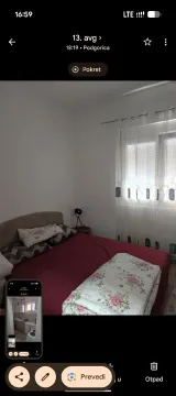 Bedroom with a double bed and a window with curtains. - image 3