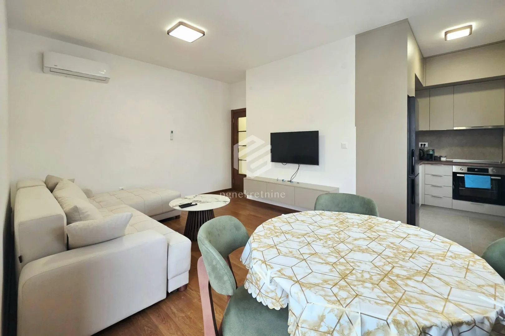 Living room with dining area and part of the kitchen.