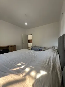 Spacious bedroom with a large double bed and a view towards the hallway and kitchen. - image 4