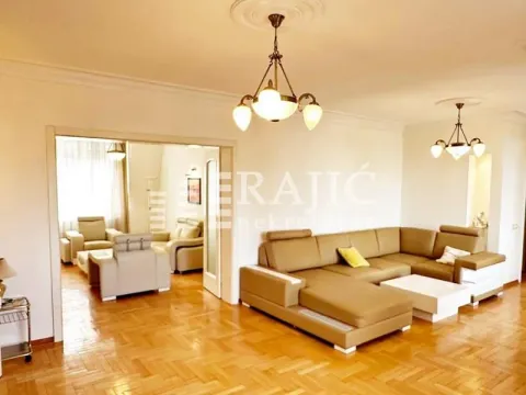 Spacious living room with a sofa set and a view into the adjoining room. - image 2