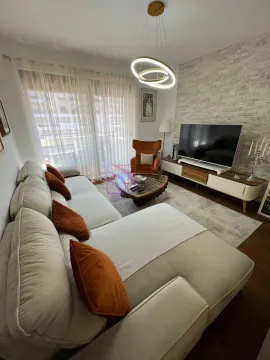 Living room with sofa, TV, and coffee table. - image 15
