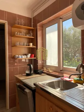 Small kitchen with a sink, countertop, and wall tiles. - image 5