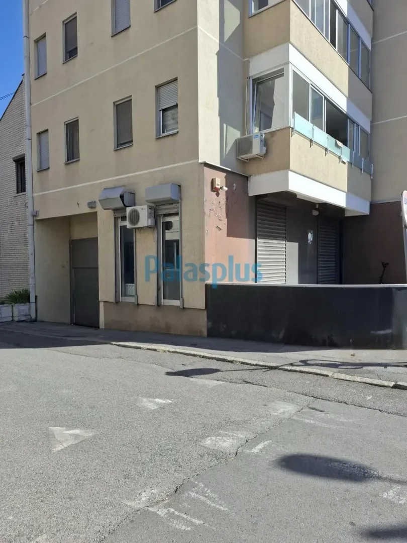 View of the exterior of the residential building with the street in the foreground.