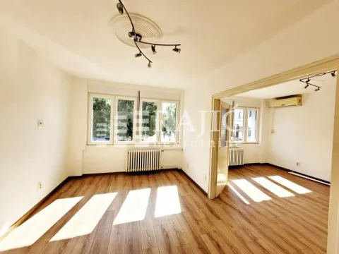 Empty living room with wooden flooring and window view. - image 3