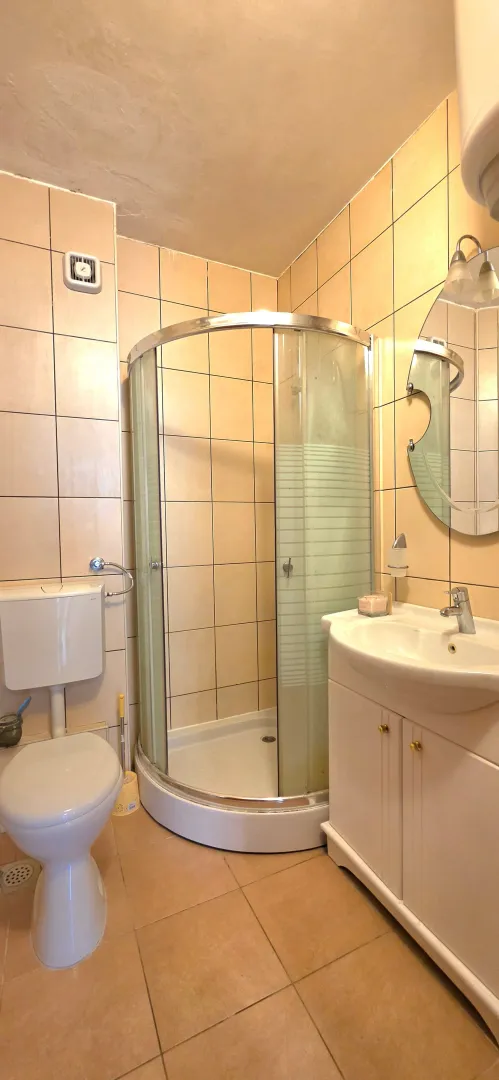 Kompaktno kupatilo sa tuš kabinom, umivaonikom i toaletom.