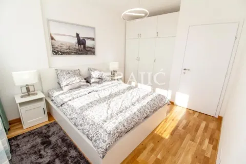 Bright bedroom with a double bed, wardrobe, and white furniture. - image 3