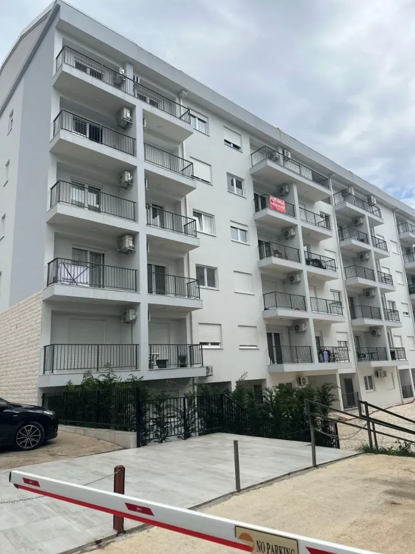 Exterior view of a modern multi-family apartment building with balconies.