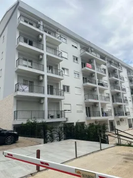 Exterior view of a modern multi-family apartment building with balconies. - image 9