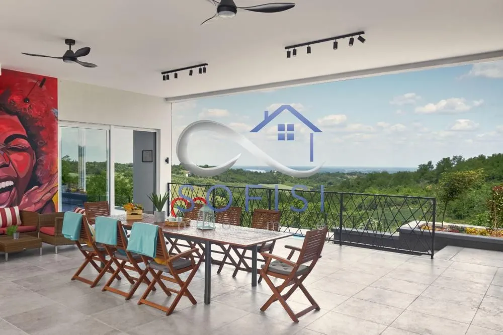Spacious covered terrace with a dining table and nature view.