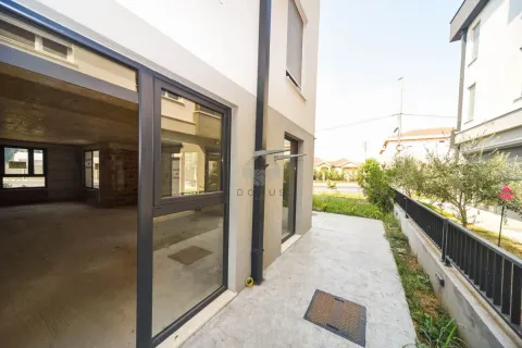 View of the exterior of the building with an entrance and yard. - image 6