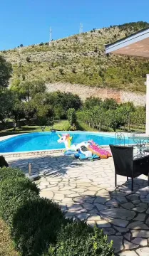 Swimming pool in the yard with a hill view. - image 4