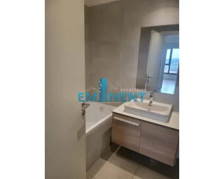 Modern bathroom with a bathtub and washbasin. - image 7