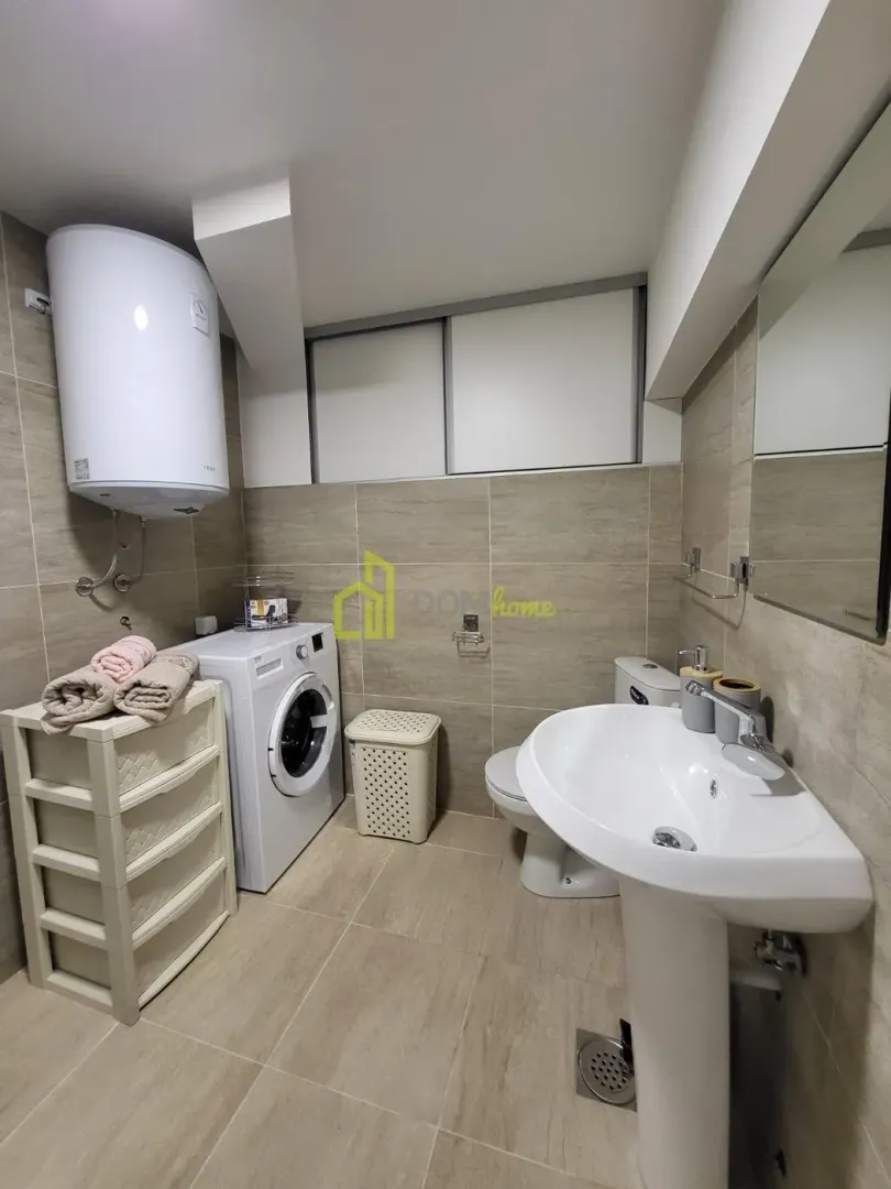 Bathroom equipped with sanitary ware, washing machine, and water heater.