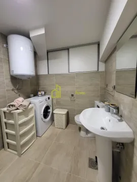 Bathroom equipped with sanitary ware, washing machine, and water heater. - image 8