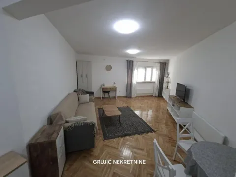 Spacious living room with sofa, TV unit and dining table. - image 3