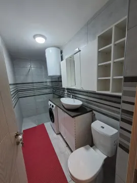 Bright and modern bathroom with a shower cabin and a washing machine. - image 2
