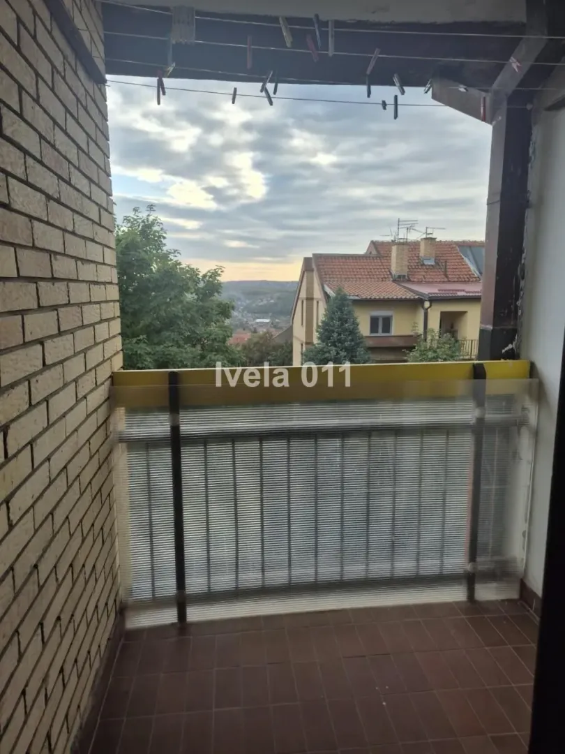 Covered balcony with a view of the surrounding neighborhood and nature.