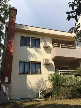 Exterior view of a two-story house with a balcony and a brick chimney. - image 3