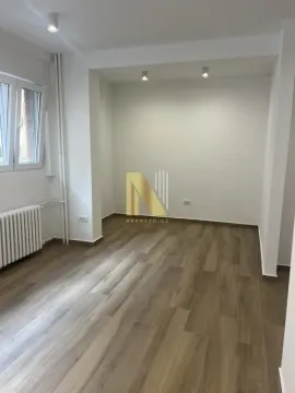 Empty room with laminate flooring and white walls. - image 5