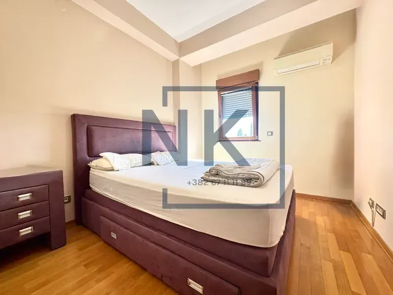 Bedroom with a double bed and a nightstand.