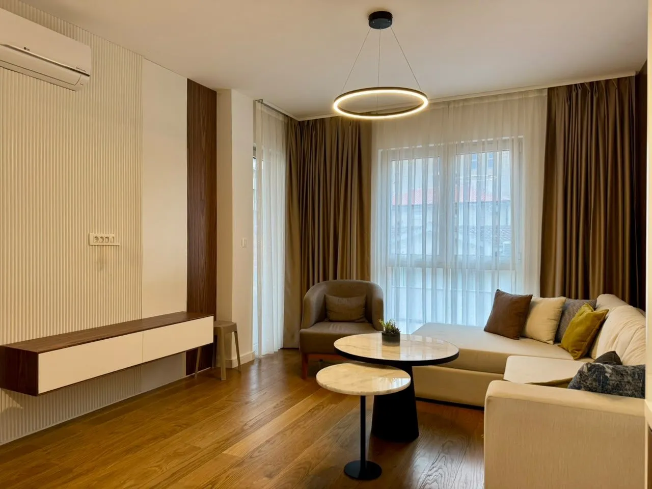 Modern and bright living room with a sofa and coffee tables.