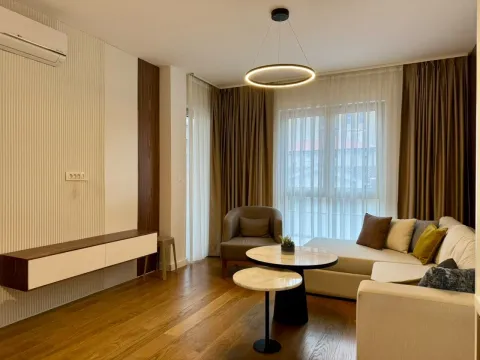 Modern and bright living room with a sofa and coffee tables. - image 6