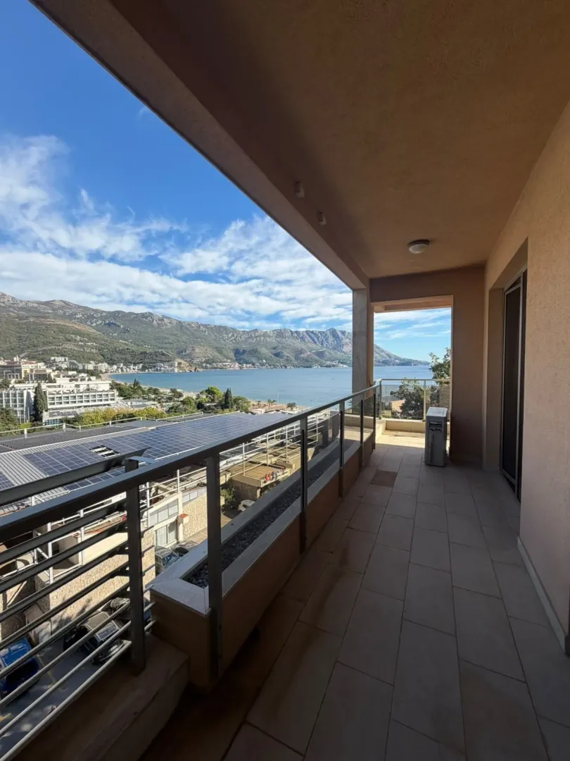 Spacious covered terrace with a view of the sea and mountains.