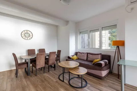 Living room with a dining table and a sofa. - image 5