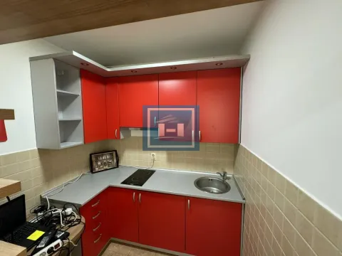 Kitchen with red cabinets and gray countertop. - image 14