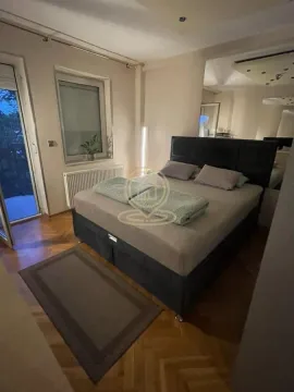 Bedroom with a double bed, parquet flooring, and access to the terrace. - image 2