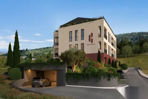 Exterior view of a modern residential building with a landscaped yard and garage area. - image 5