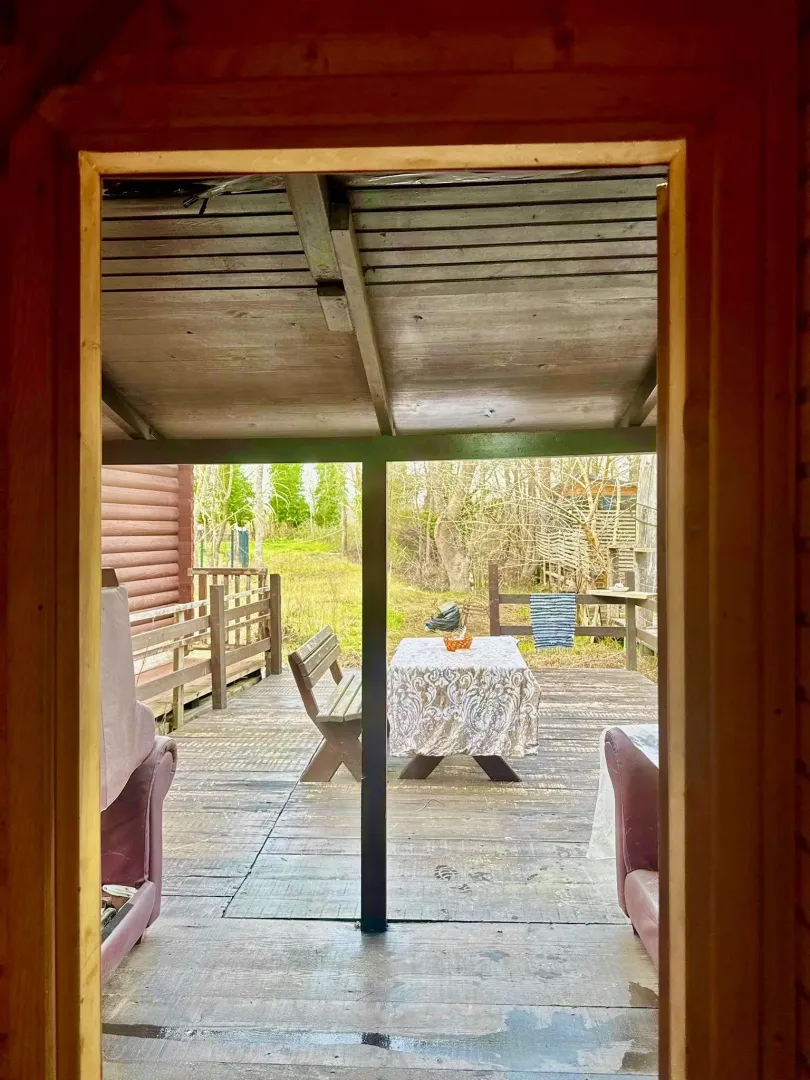 Wooden terrace with a table and benches.