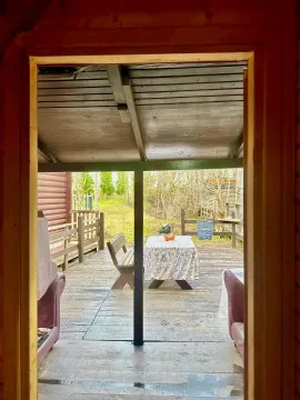 Wooden terrace with a table and benches. - image 7