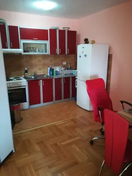 Kitchen with red cabinets and appliances. - image 4
