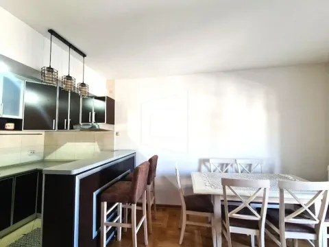 Kitchen with a bar counter connected to the dining area. - image 3