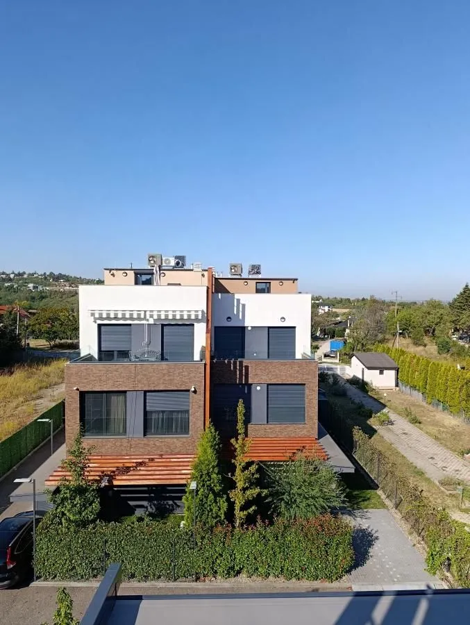 Elevated view of the exterior of a modern residential building and landscaped courtyard.