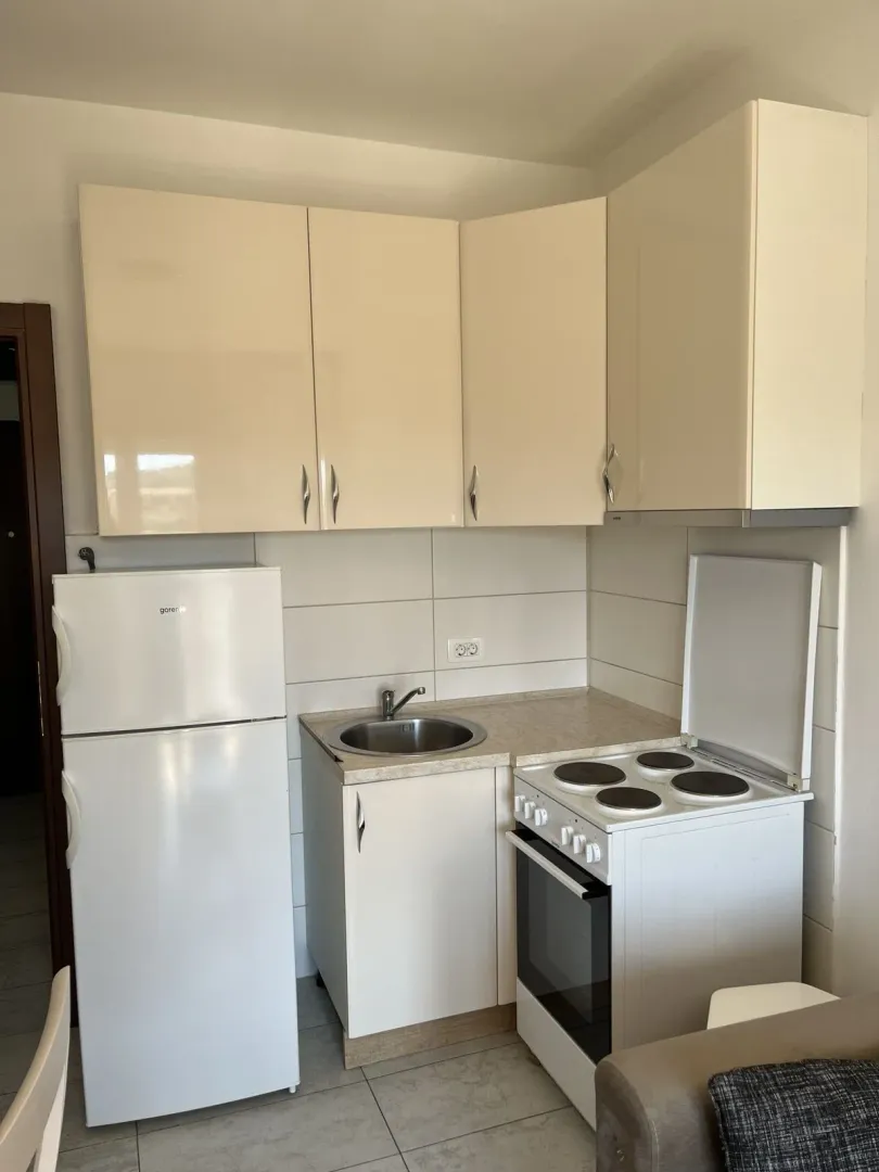 A small kitchen with appliances and cabinets.