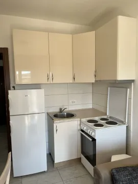 A small kitchen with appliances and cabinets. - image 5