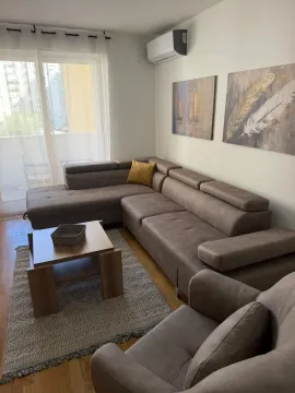 Comfortable living room with a sectional sofa, coffee table, and access to the terrace. - image 14