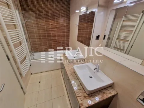 Modern bathroom with two sinks and a bathtub. - image 15