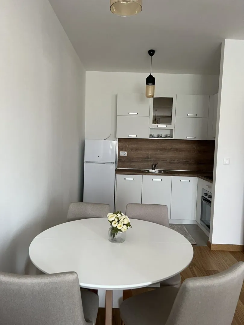 Bright kitchen with a round dining table and chairs.