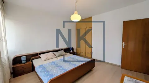 Furnished bedroom with a double bed, wardrobe, and wooden flooring. - image 6