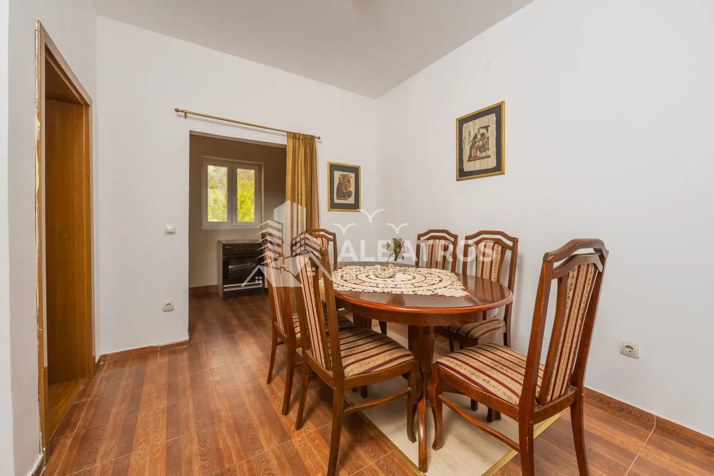 Dining area with a wooden table and chairs.