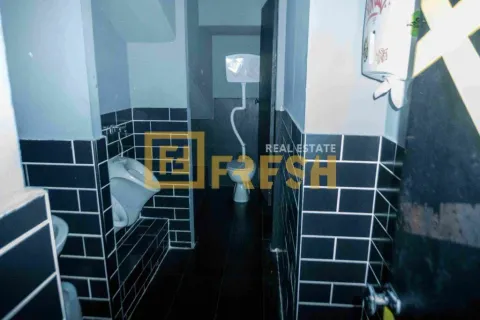 View of the bathroom with dark tiles and sanitary fixtures. - image 3