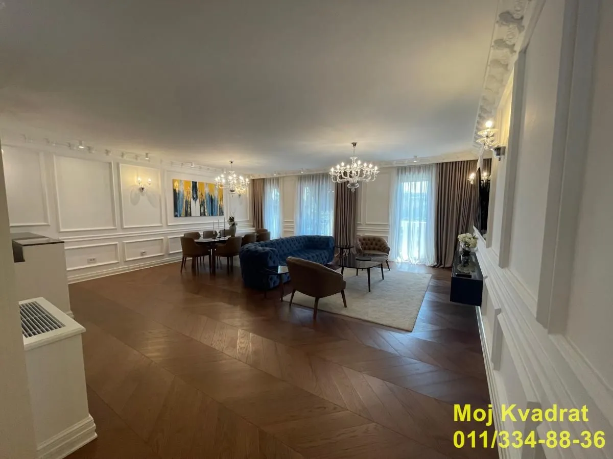 Spacious living room with a sofa set, dining area, and hardwood flooring.