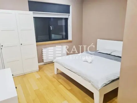 Furnished bedroom with a double bed, white wardrobe, and a window. - image 7